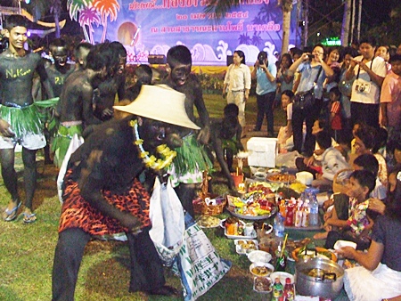 Devils swoop in to gather and eat the food and desserts.