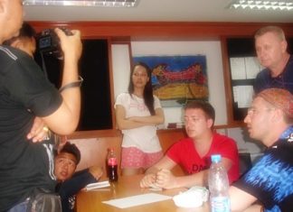 Napat Chamnanphote (background, center) denies charges he tried to steal Oleksandr Semenets’ gold chain.