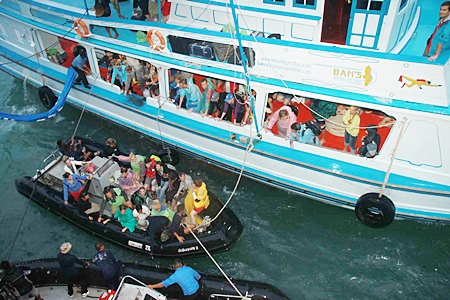 Soggy, exhausted tourists were shuttled to the warships in small wooden and rubber boats, as the waters off the islands were too shallow for the Navy vessels.