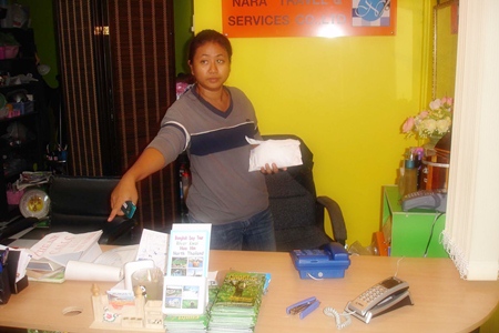 Kwandao Wingwon points to the spot where her computer once was, before long shark enforcers took it for lack of payment. 