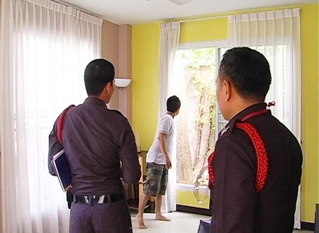 Police examine the suspected entry and exit point of the burglars.