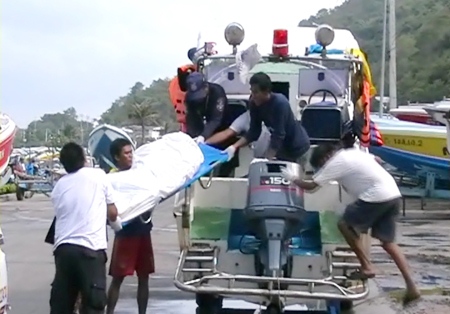 Sawang Boriboon Foundation volunteers assist Pattaya Sea Rescue staff after they brought the floating corpse ashore Wednesday.