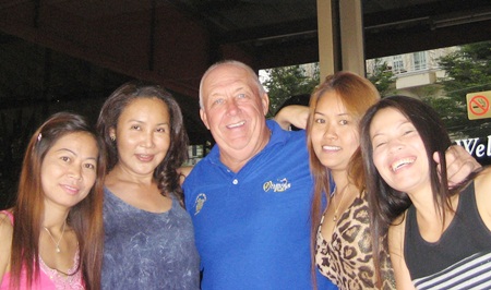 JJ, center, celebrates his win with the staff at Kisses Bar. 