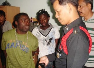 The two Cameroonian football players are arrested by police at their south Pattaya apartment.