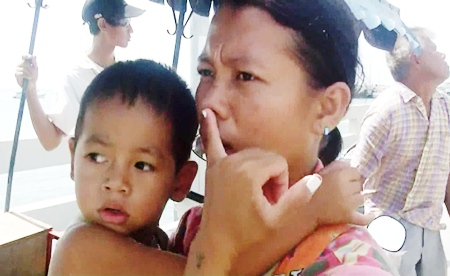 The boys anxious mother explains to paramedics about the ball that is lodged in her sons nose.