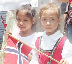 Many participants, especially the children, wore national attire and waved Norwegian flags.