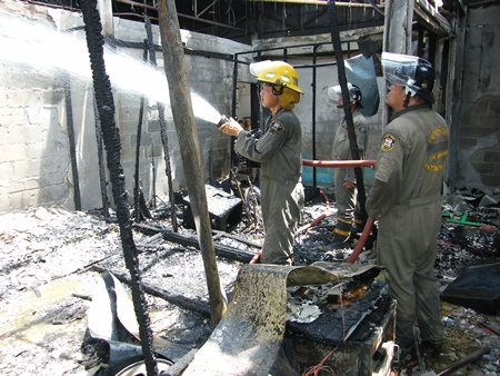 Firefighters put out the last few embers of a horrific fire that took too lives at the Music Studio in Duck Square. 