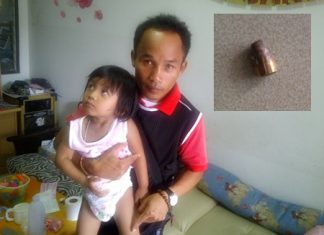 Krok Virachon shows where a mystery bullet (inset) crashed through the roof of his house and hit his 2-year-old daughter.