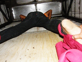 Rescue workers try to free 16-yewar-old Yongyut Prakobsuk who somehow managed to get his head stuck in the dumbwaiter. 