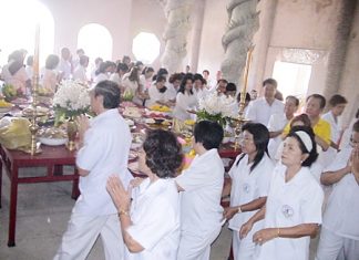 Public officials and community leaders from around Sriracha perform the Wien Thien during the foundation stone ceremony.