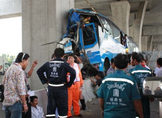 Rescue workers swarm around the crash scene where 2 people were killed and dozens others injured.