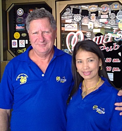Neville, left, celebrates his win with one of the staff members outside Mama’s Bar. 