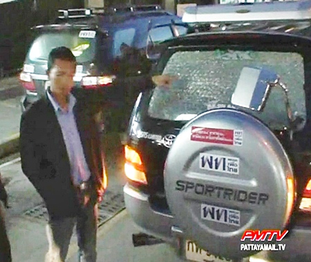 Police examine the smashed window.