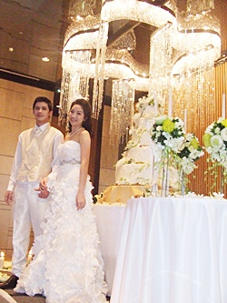 Models Palm and Yui wearing wedding attire pose in the Seaboard Ballroom of Hilton Pattaya.