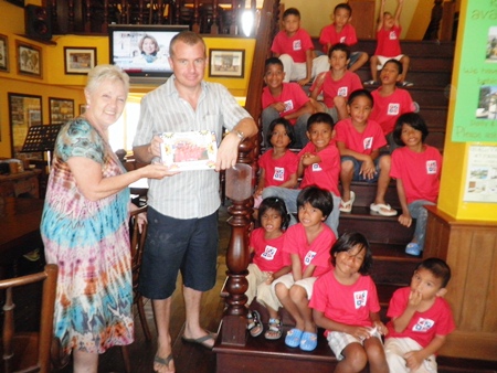 Eddie’s reward for this third year of hospitality for Mercy Center is a memento created by the children and presented by one of its directors, Dianne Doell.