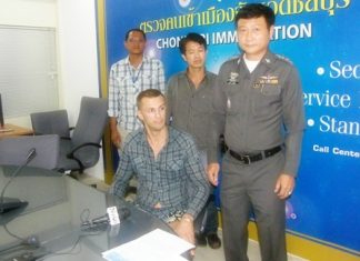 Chonburi Immigration Police have arrested Andrey Kozlov (seated) on a request from a Vladimir, Russia court.