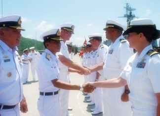 Royal Thai Navy Vice Adm. Surachai Sungkhapong greets U.S. Navy officers during the CARAT 2011 closing ceremony.