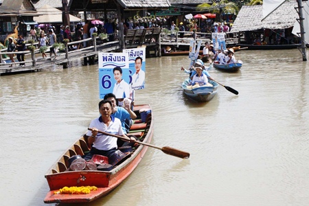 Palang Chon candidates take to boats to hand out leaflets promoting their political platform.