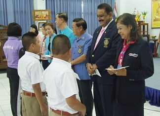 Rotarians hand out scholarships to deserving students.