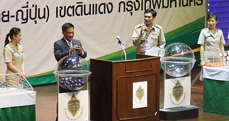 Apichat Sukakkanon, chairman of the Election Commission, presides over the random drawing to determine where each political party will be listed on the July 3 ballot. 