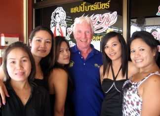 Geoff, center, celebrates his win with the staff at Happy Bar 2.