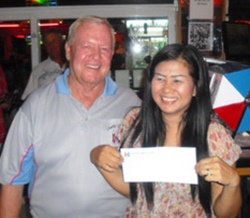 Noi Emmerson, right, proudly shows her prize for winning the Ladies Flight.