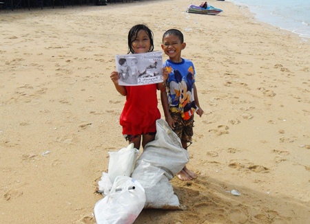 My, 8 years old, and friend Pepe, 8, pitch in to clean up.