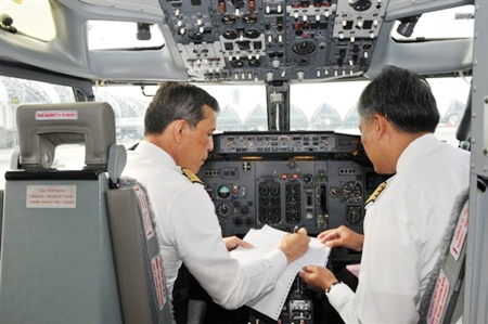 His Royal Highness Crown Prince Maha Vajiralongkorn goes through pre-flight preparations before takeoff on a special Buddhist Pilgrimage Flight he piloted to India.
