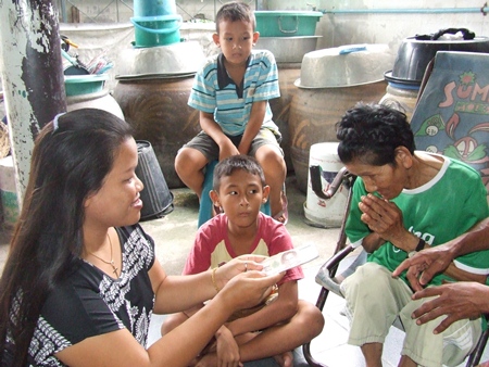 A kind hearted British man (not shown) and his Thai wife (left), both of whom wish to remain anonymous, donate funds to help the plight of Grandma Bunlert and her family. 
