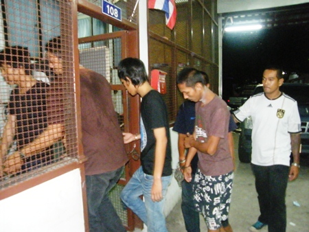 Some of the many suspects caught at the polls are led into the station for processing. 