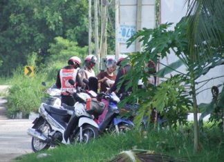 The two men on the left are traffic volunteers and the real NCO-traffic policeman is on the right at this illegal and hazardous checkpoint.