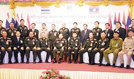 Military officials, led by Lt. Gen. Witsanu Sriyapan, director-general of Thai Border Military Affairs, and Gen. Bualiang Champaphan, deputy chief of staff for the Lao People’s Army (both seated, center) pose for a commemorative photo after the meeting. 
