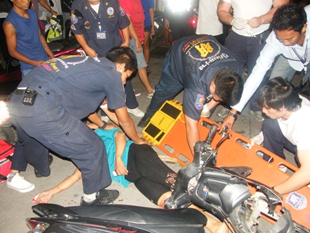 Sawang Boriboon Foundation rescue workers tend to the injured motorcycle accident victim, Somjai Kolansky. 