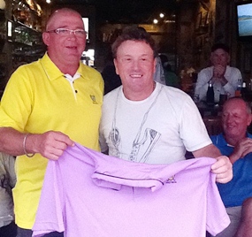 Brad Sproxton, left, presents Paul Smith, right, with the champion’s shirt following the June Monthly Medal. 