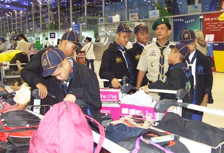 The blind scouts prepare to check their luggage at the airport check-in counters.