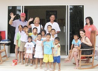 John & Wendy Khan (center) of “We2R1” will be performing Live 60s and 70s music for the Mercy Center Children’s Home Grand Opening. Also shown are Mercy family members in front of their “Forever” Home Baan Khong Por in Pong.