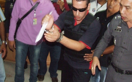 Mohammad Shanar shows police and the media how he brutally murdered Charles E. Jones.