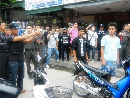 Angkul Srihanan shows police and onlookers how he allegedly murdered two men on the streets of Pattaya. 