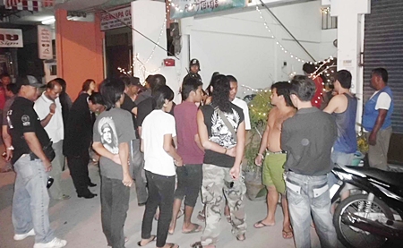 Crowds gather outside the Khrua Mai Man Karaoke where the shooting occurred. 