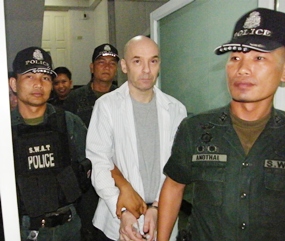 Fifteen years after allegedly chopping up his wife in a Pattaya hotel, Canadian Michael Karas is finally escorted into a jail in Pattaya.