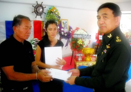Father and grieving widow accept compensation for Lieutenant Commander Pipatpoom Srikadkao, who died in service of his country. 