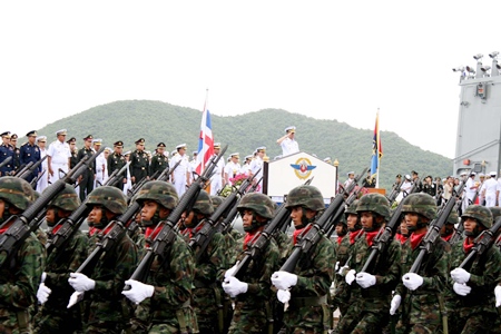 Troops march past the soon to be retired Chief of Defense Forces Gen. Songkitti Jaggabatara.