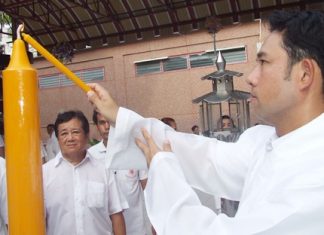 Mayor Itthiphol Kunplome lights some incense to summon different deities to impress upon the festival.