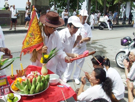 Business owners and residents who have put out worship altars along the parade route, present garlands and receive blessings for prosperity.