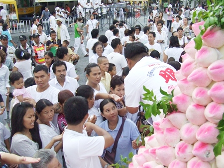 Participants line up for their share of the peach shaped dumplings. (Photo by Phasakorn Channgam)
