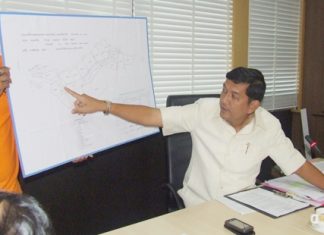 During a press conference with several owners of businesses in South Pattaya, Chawalit Saeng-Uthai points to a map of the area that needs clearing out.