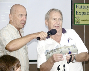 ‘Hawaii Bob’ Sutterfield draws the lucky names for the PCEC members’ draw for special deals in Pattaya’s better value restaurants. Bob is aided by Open Forum MC, Roy Albiston.
