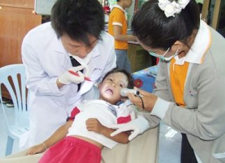 A little guy has his teeth checked by professional doctors from Bangkok Hospital Pattaya.