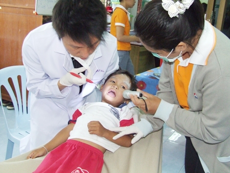 A little guy has his teeth checked by professional doctors from Bangkok Hospital Pattaya.