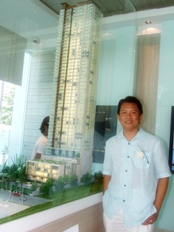 Vichapol Srisuriyachai, managing director of Bellagio Development Co. Ltd., stands next to a model of the new Cetus Condominium during the launch of the project’s showroom, Saturday, October 1.